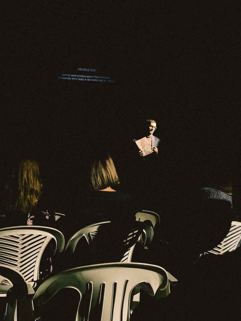 A theatre stage mid-rehearsal, messy but alive.